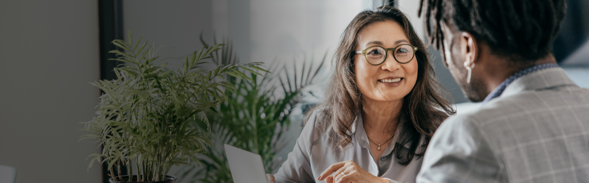 Photo of woman in business attire smiling at man